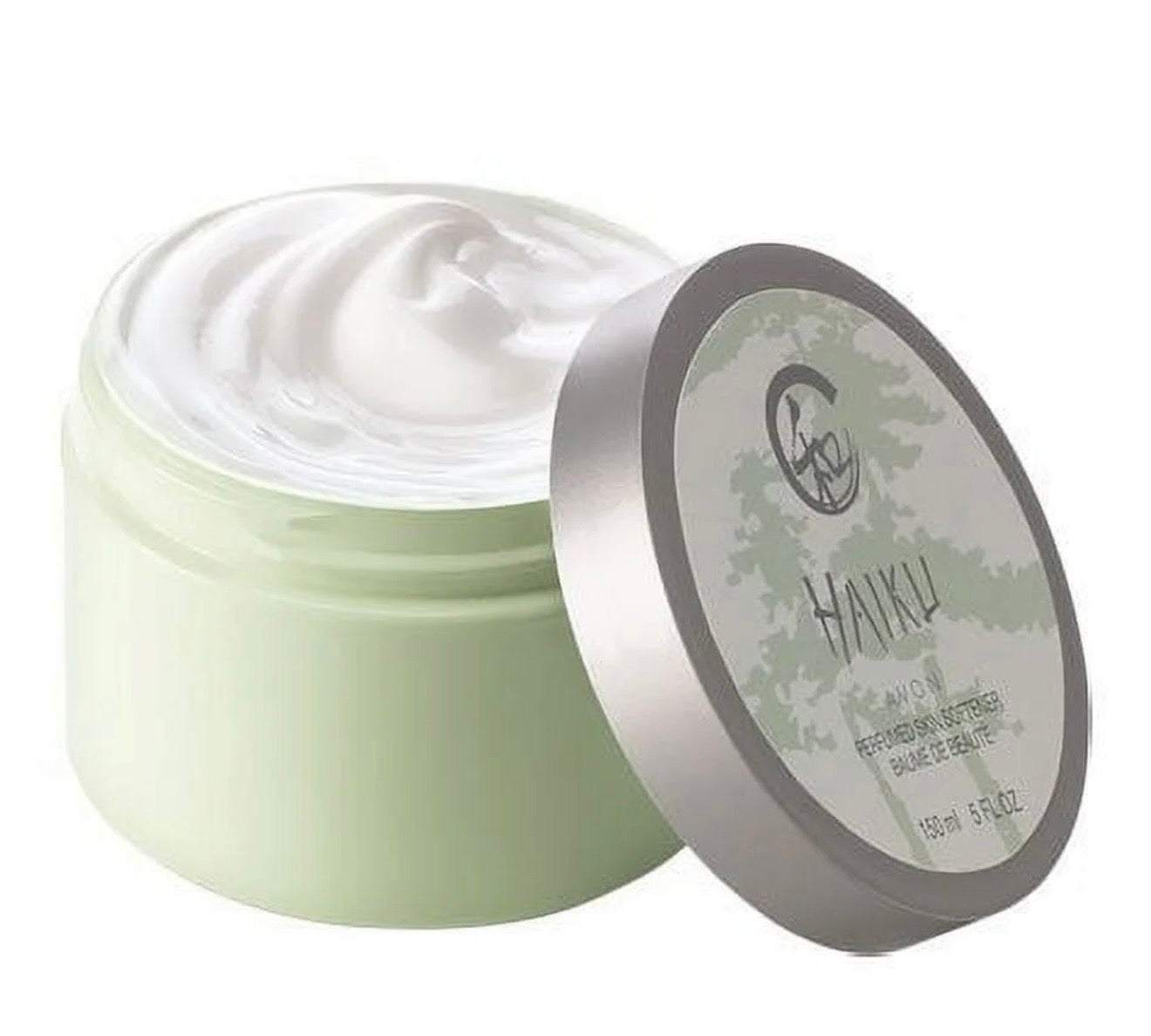 Open jar of Haiku perfumed skin softener with creamy white texture and silver lid
