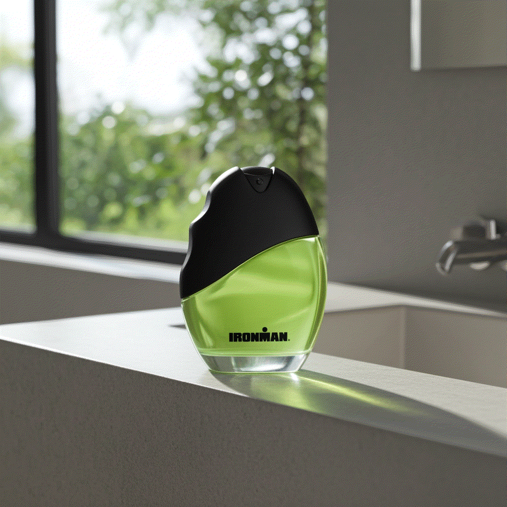 Ironman Eau De Toilette men’s cologne spray 2.5 fl oz with green liquid and black cap on white surface