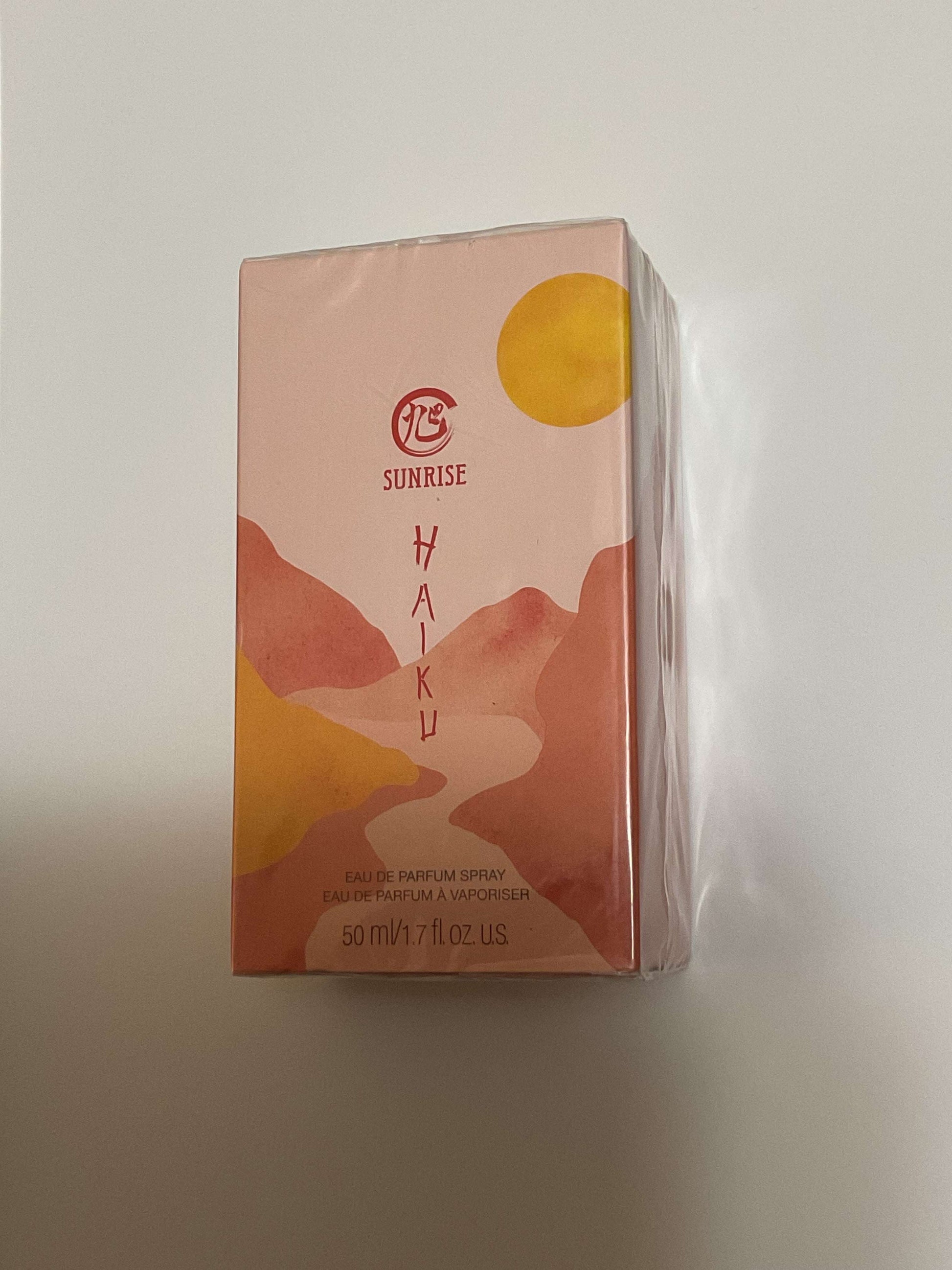 Haiku Sunrise Eau De Perfume 1.7 fl oz packaging with sunrise and mountain design
