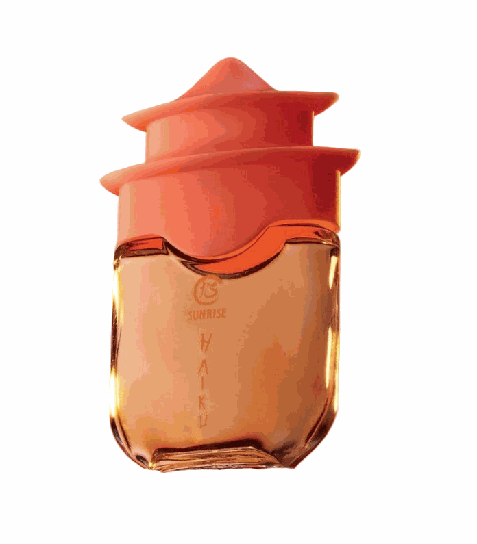 Haiku Sunrise Eau De Perfume bottle with orange cap and amber liquid reflecting warm cedarwood and coconut water scents