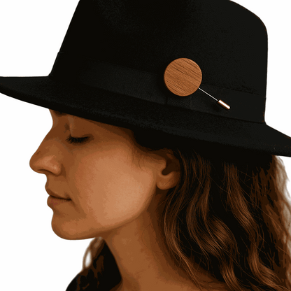Mahogany Heritage Accent Pin on black hat worn by woman, handcrafted wooden accessory symbolizing heritage and natural luxury