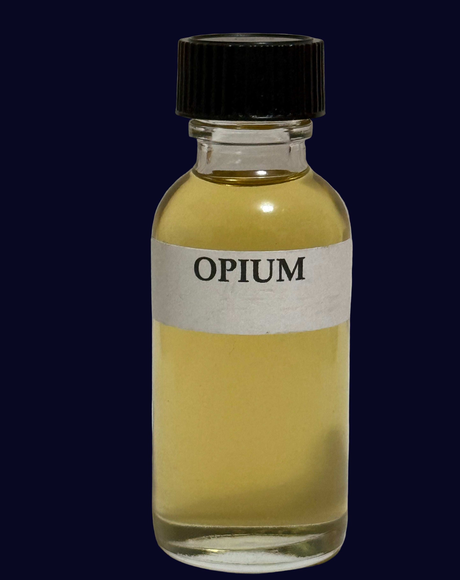 Opium Perfume Oil bottle with amber-colored fragrance and black cap on dark background