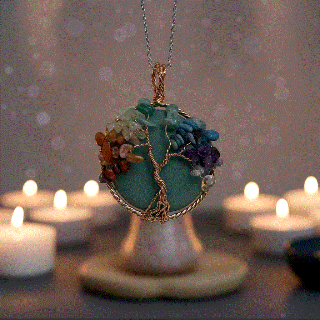 7 Chakra Tree Of Life pendant with green aventurine and copper wire wrapping, featuring seven chakra crystal chips on a black leather cord.
