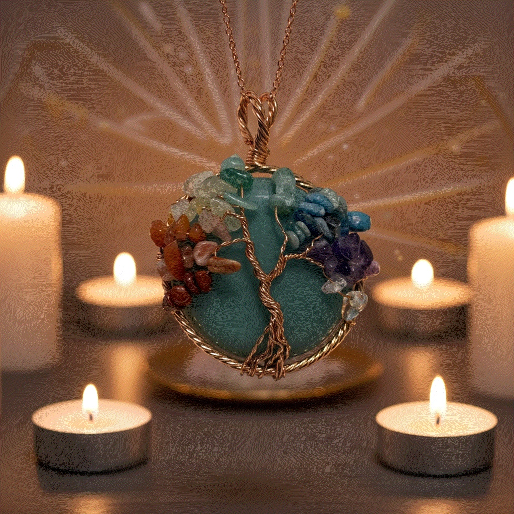 7 Chakra Tree Of Life pendant with green aventurine and copper wire surrounded by lit candles