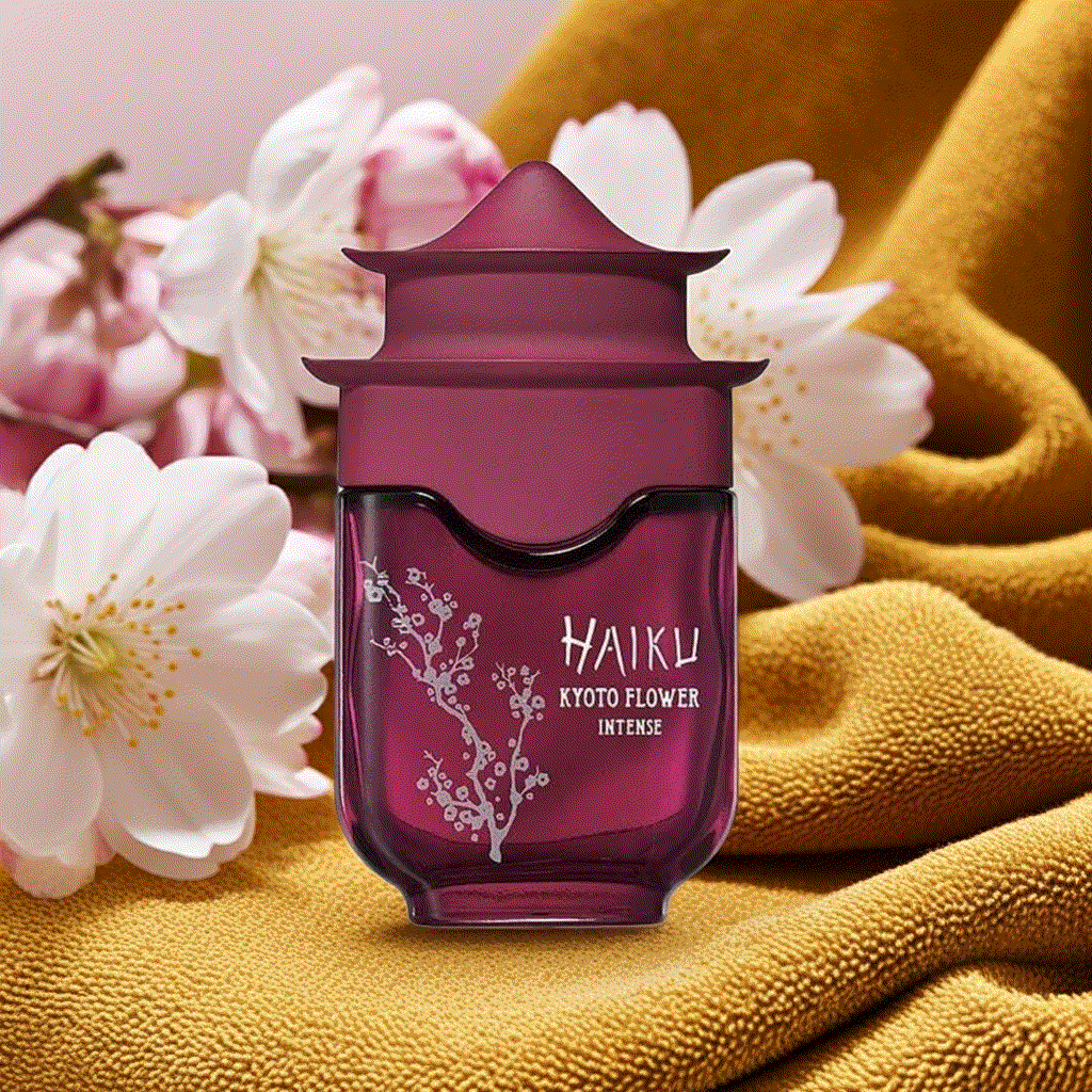 Haiku Kyoto Flower Intense perfume bottle with floral design and soft blossoms on mustard fabric background