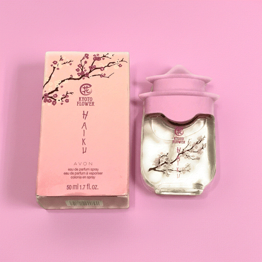 Kyoto Flower Haiku perfume bottle and pink cherry blossom packaging on pink background