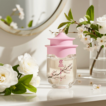 Kyoto Flower Haiku perfume bottle with pink cap surrounded by white flowers on table