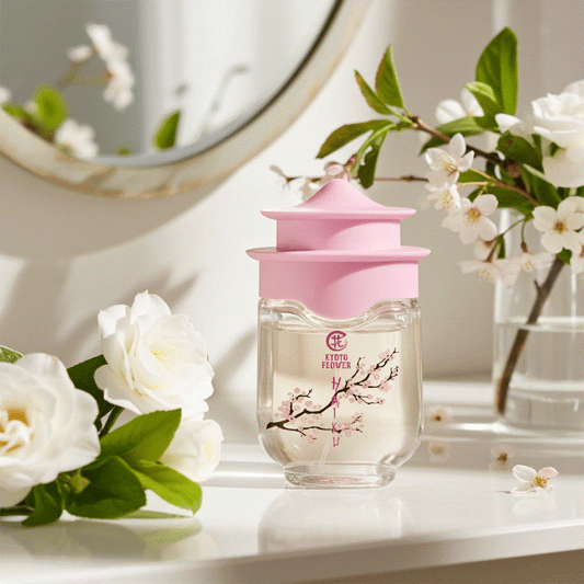 Kyoto Flower Haiku perfume bottle with pink cap surrounded by white flowers on table