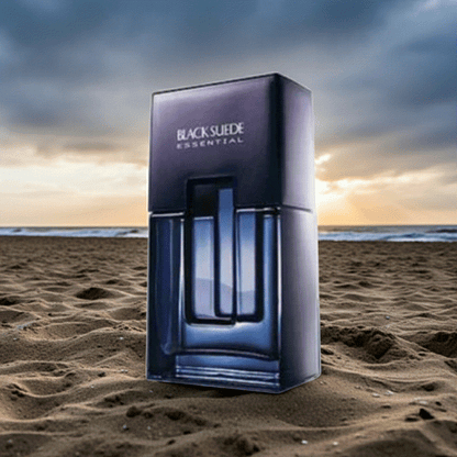 Black Suede Essentials men's cologne bottle and packaging on sandy beach at sunset