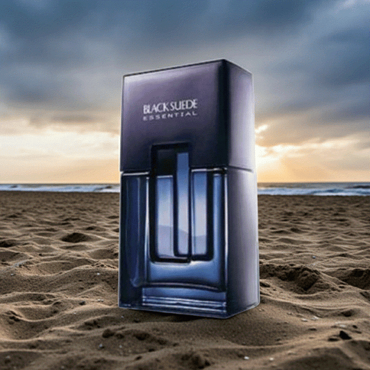 Black Suede Essentials men's cologne bottle and packaging on sandy beach at sunset